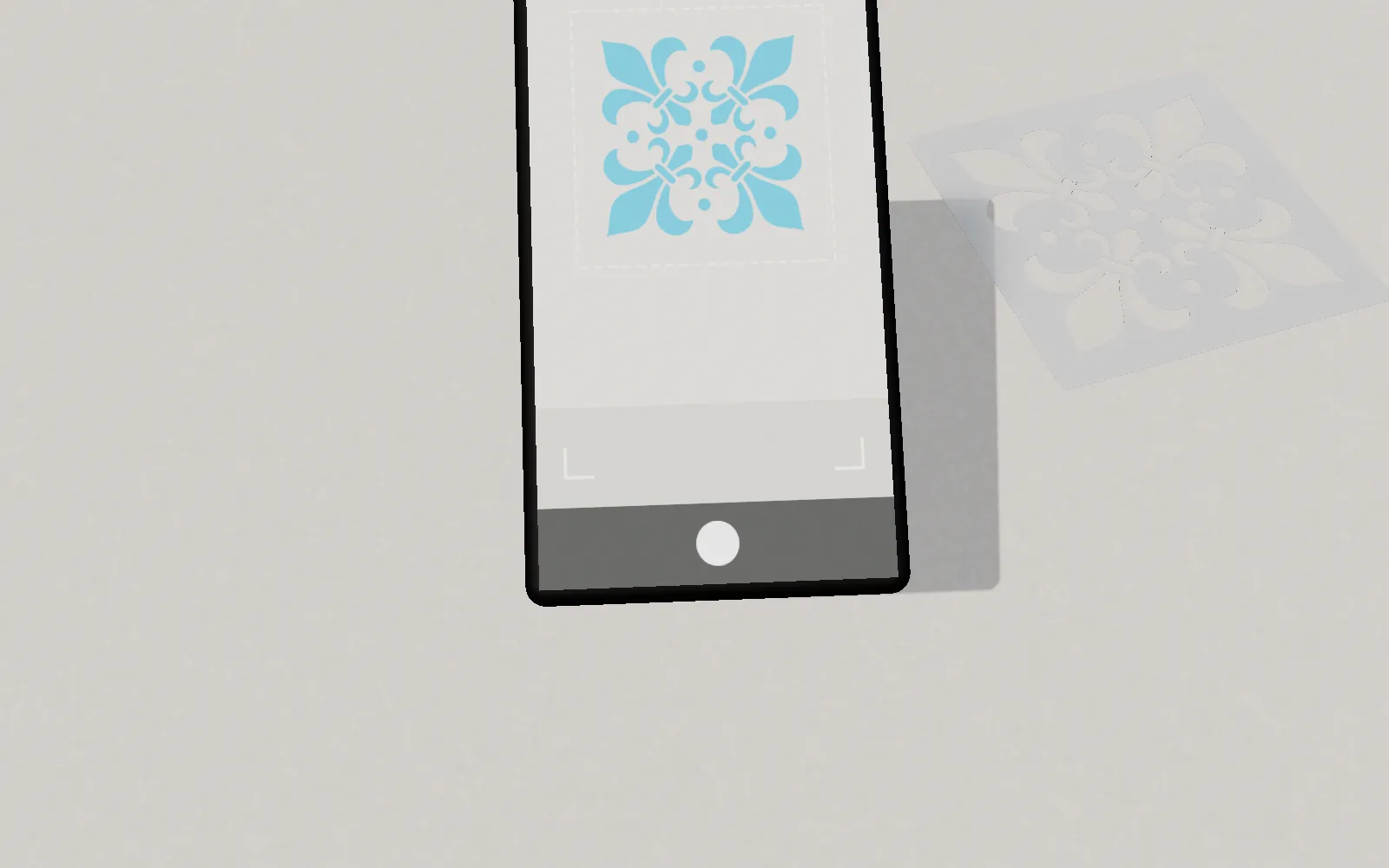 A phone held over a wall showing the stencil in augmented reality at real scale, before anything is cut