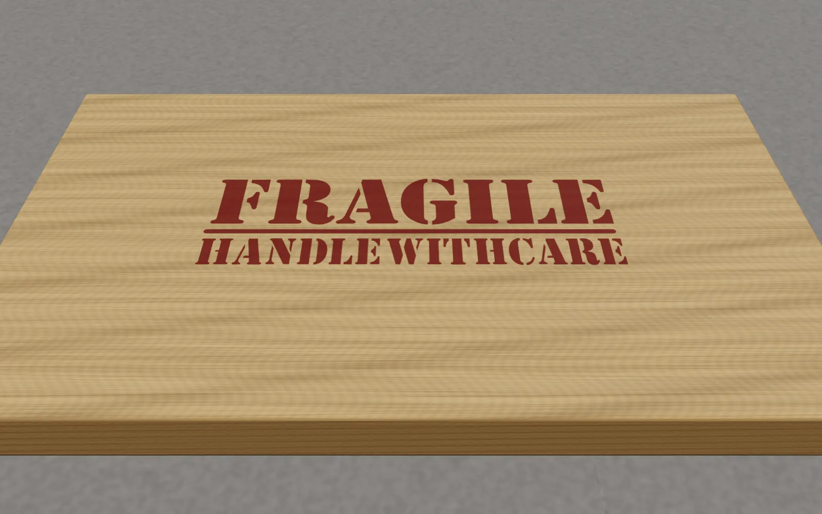 Il coperchio di una cassa di legno marcato con lo stencil «Fragile – handle with care» in rosso