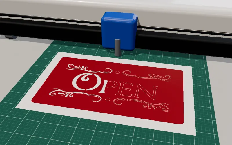 Ein Schneideplotter schneidet das Wort OPEN in ein Blatt rote Vinylfolie auf einer grünen Schneidematte
